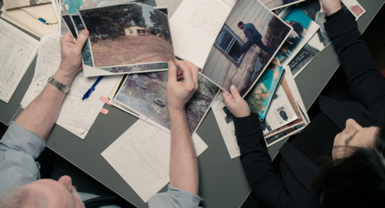 Detectives sorting through crime photos